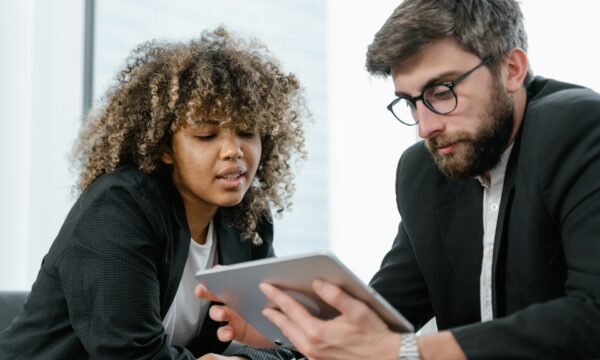 man and woman looking at a tablet